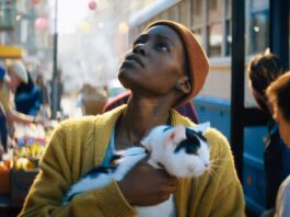 Lupita N'yongo Looks to the sky in a scene from A Quiet Place: Day One